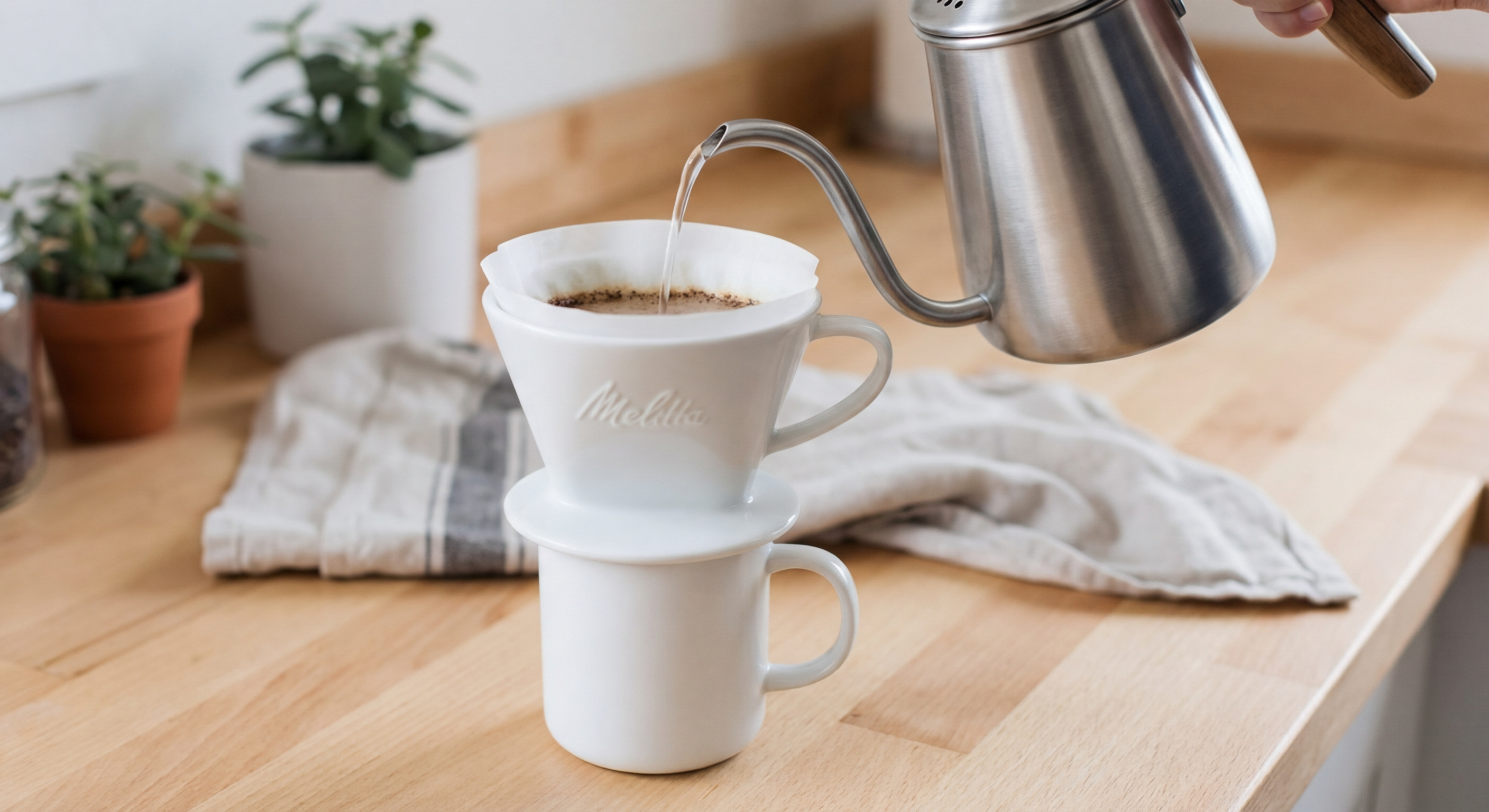 Melitta ceramic dripper with pour-over filter and cup, showing eco-friendly single serve coffee setup